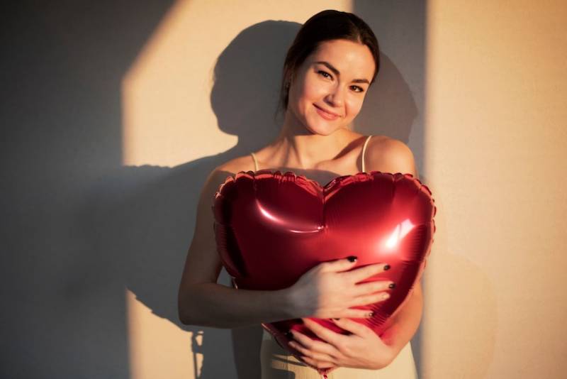 woman-holding-red-heart-shaped-balloon-self-love-celebrating-valentines-day