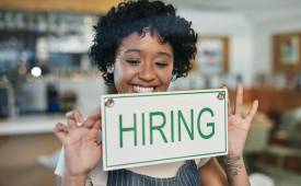 businesswoman-owner-smiling-hiring-sign