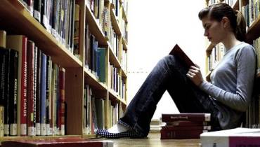 young-woman-reading-book-content-strategy-in-library