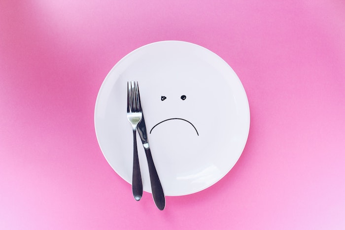 sad-face-on-empty-plate-with-fork-knife.jpg