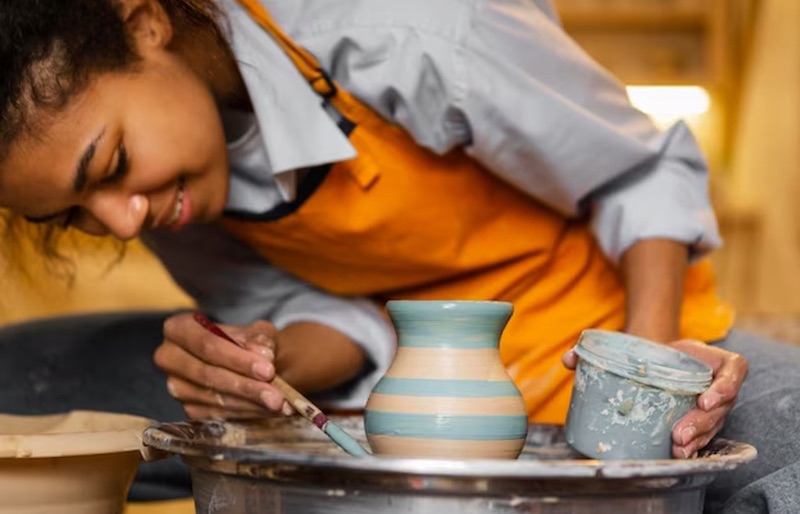 Smiley artist painting clay pot passion project and hobby