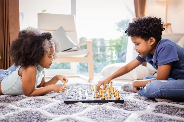 Boy-girl-kids-playing-chess-board-games-home-activity.