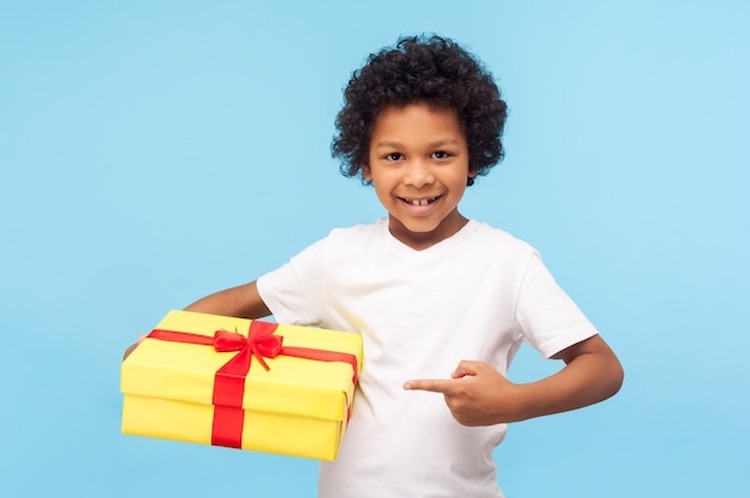 Boy-holding=and-point-at-gift-box-happy.