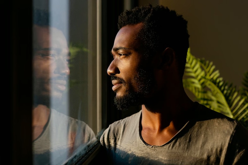 close-up-man-posing-near-window-reflecting