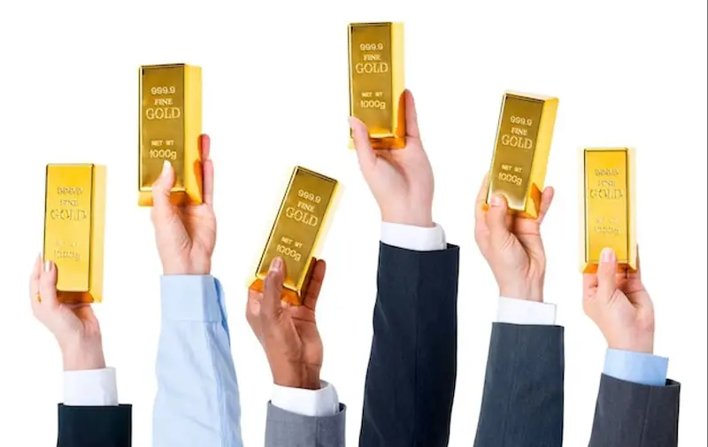 hands-holding-gold-bars