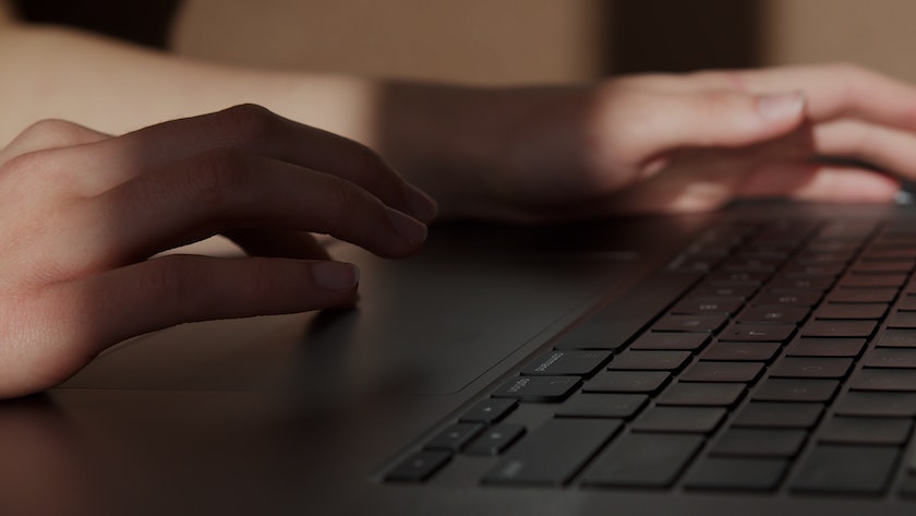 hands-laptop-touchpad-keyboard-writing