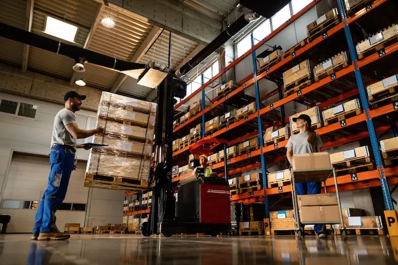 happy warehouse workers communicating while working