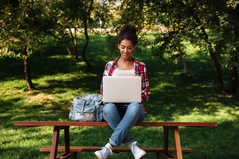 young-lady-student-sitting-outdoors-nature