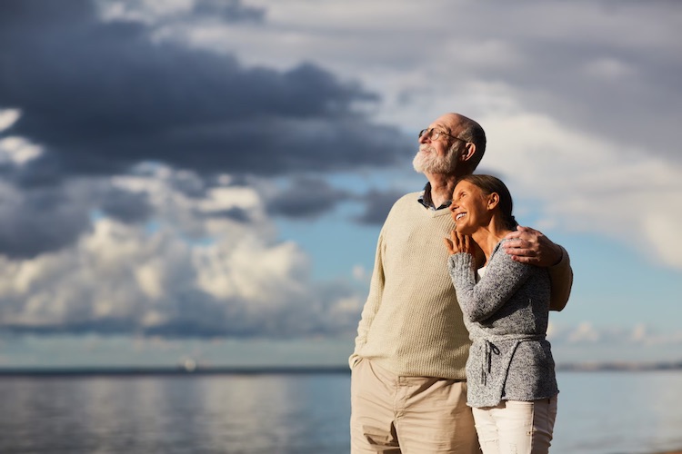 senior-couple-enjoying-evening-by-seaside-happy