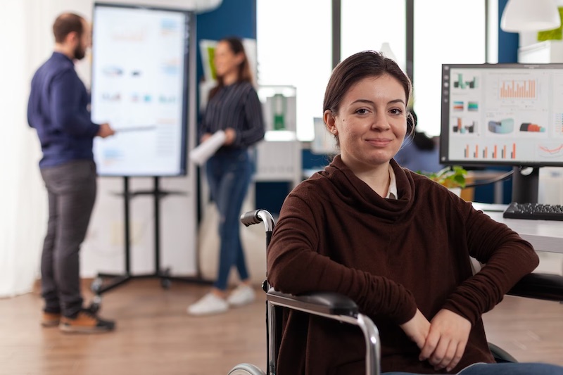 teen girl working in startup in wheelchair