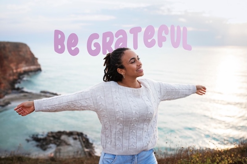 woman-arm-spread-happy-seaside-greatful