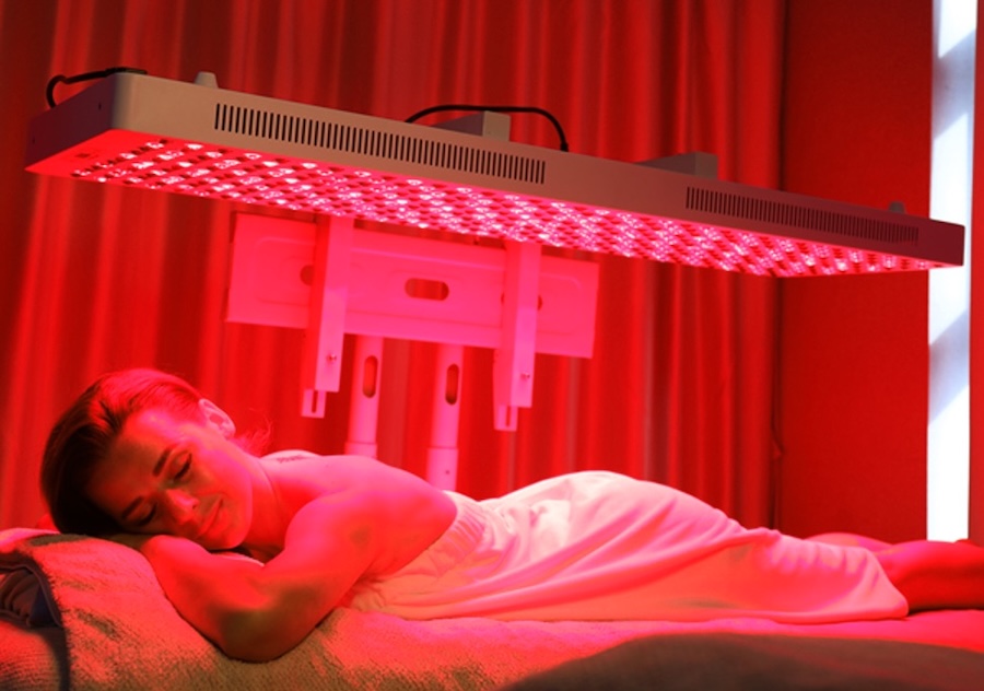 young-woman-lying-bed-red-light-therapy