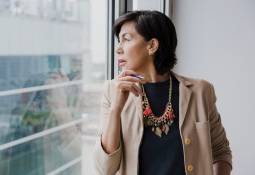 business-woman-by-window-looking-away-medium-shot-avoid-cognitive-bias