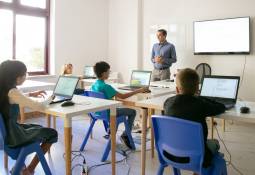 classroom-teacher-explaining-lesson-pupils-pros-cons-of-AI-in-education