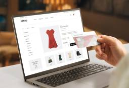 ecommerce web page with woman clothes on laptop display