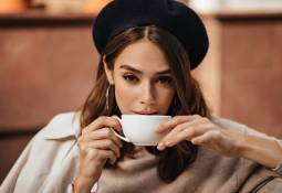 elegant-young-woman-drinking-coffee-from-white-cup