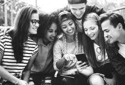 Diverse Group of Young People Happy Looking at Smartphone Image for 5 Unique Career Paths for Millennials and Gen Z in 2022