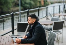 businessman-outdoor-cafe-laptop-pen