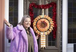 woman-smiling-iceland_prawn_ring_wreath-front-door