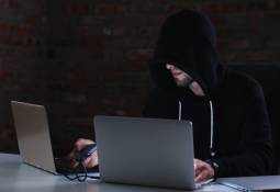 man-hacker-laptop-ai-scam-alert