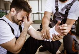 man-injured-arm-hurt-first-aid-worker-helping