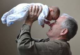 man-lifting-baby-up-happy-older-parent