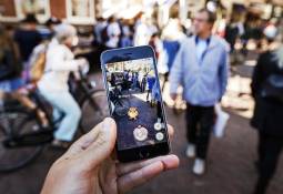 person-holding-smartphone-pokemon-go-app-image