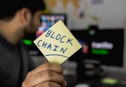 man_holding_card_blockchain_benefits