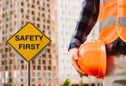 safety-first-sign-man-holding-helmet