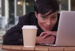 woman-laptop-coffee-cup-looking-ahead-tendency-to-procrastinate