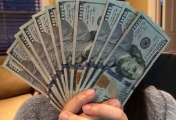 person_holding_cash_notes_over_face_personal_loan_no_guarantor