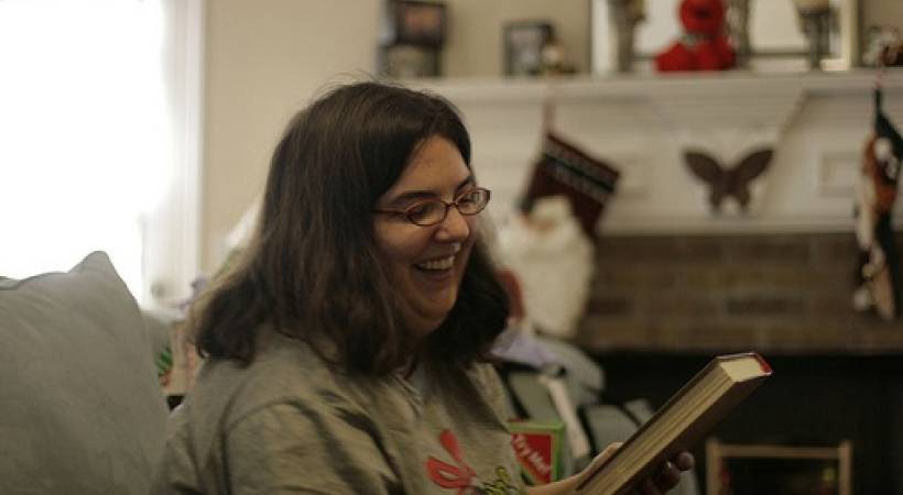 Woman-Smiling-Admiring-Book-Christmas-Ideasfor-Book-Lovers
