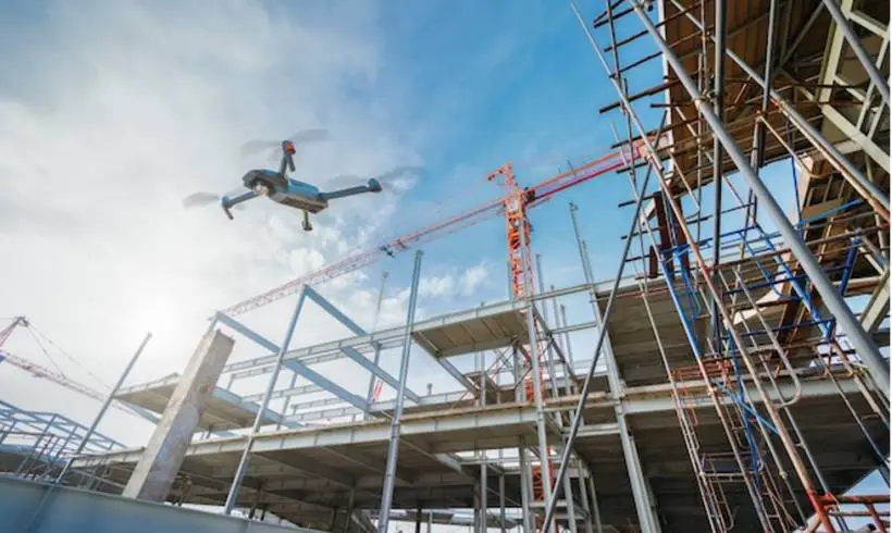 Drone flying over construction site for surveillance or industrial inspection