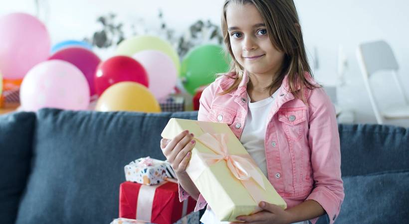 Girl in Pink Jacket Holding a Gift