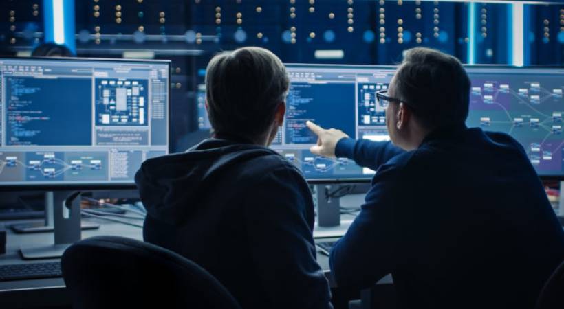 IT-team-pointing-computer-screen-ai-cybersecurity-threats