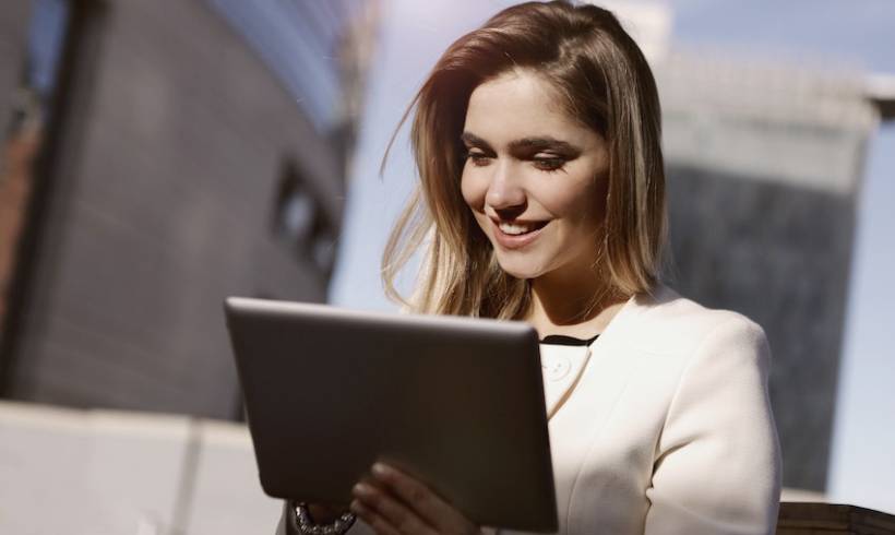 Businesswoman Happy With Tablet Image for Advice Every Entrepreneur Needs to Hear for Success