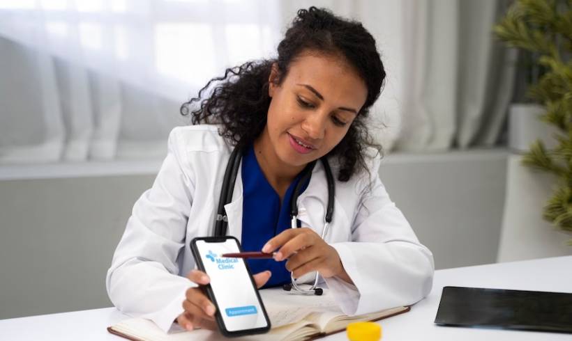 female-doctor-holding-smartphone-showing-medial-app