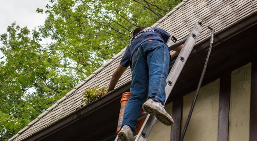 man-cleaning-gutter
