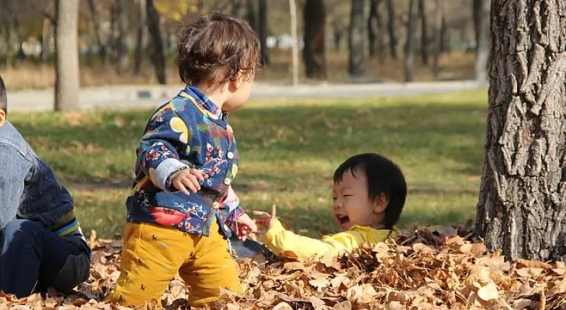 happy-kids-playing-autumn-nature - How Nature Impacts Children’s Well-Being Illustration