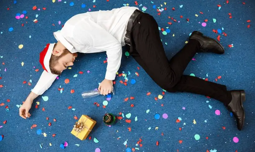 man-passed-out-office-holiday-party-mistakes