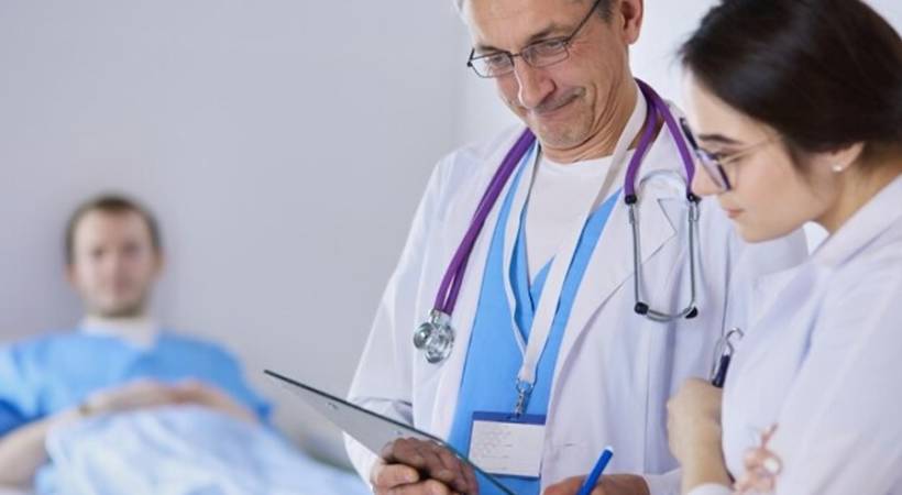 medical team of doctors man and woman checking healthcare records