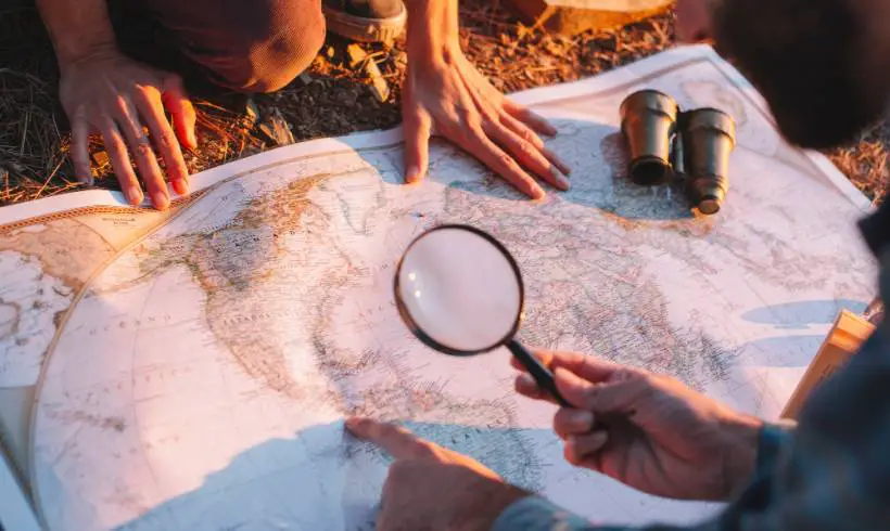 men-exploring-map-treasure-hunting