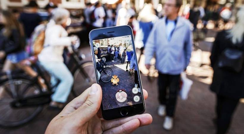 person-holding-smartphone-pokemon-go-app-image