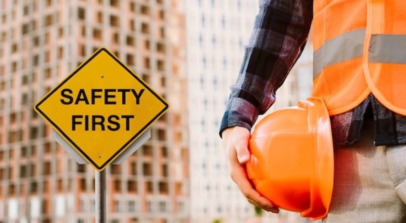 safety-first-sign-man-holding-helmet