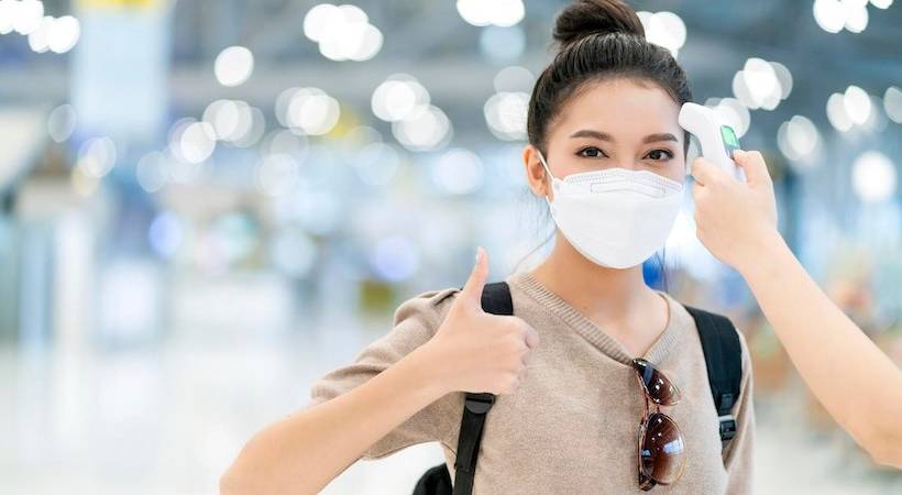 woman-wearing-covid-mask-airport-terminal