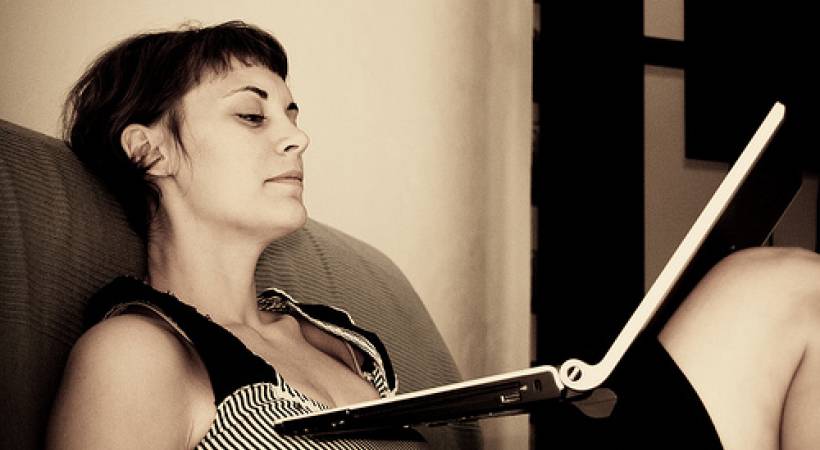woman-sitter-reading-on-laptop-boring-word-substitutions