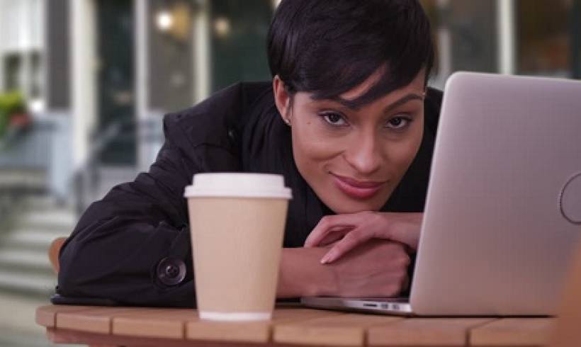 woman-laptop-coffee-cup-looking-ahead-tendency-to-procrastinate