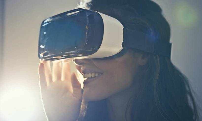 Woman-smiling-wearing-white-virtual-reality-goggles-vr-boom-trends