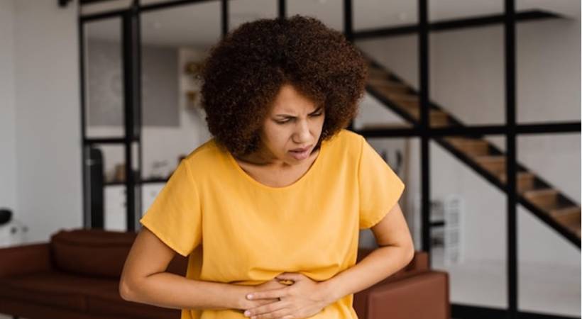 woman holding abdomen stomack upset and bloating