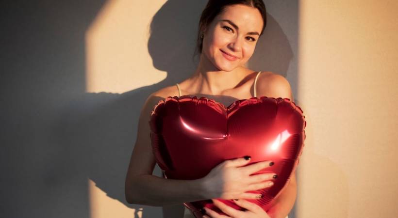 woman-holding-red-heart-shaped-balloon-self-love-celebrating-valentines-day